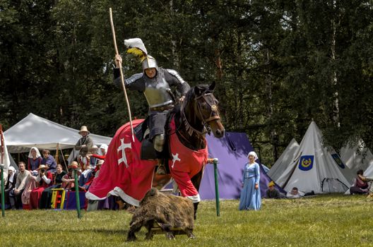 CHORZOW,POLAND, JUNE 9: Medieval knight on horseback showing their skills during a IV Convention of Christian Knighthood on June 9, 2013, in Chorzow