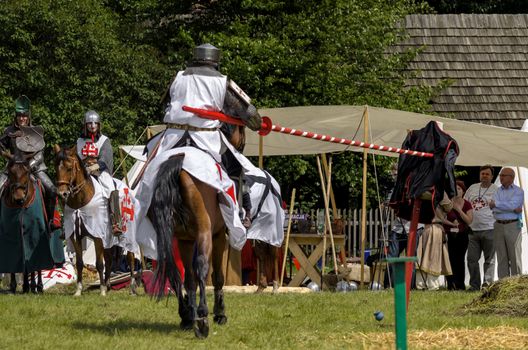 CHORZOW,POLAND, JUNE 9: Medieval knight on horseback showing their skills during a IV Convention of Christian Knighthood on June 9, 2013, in Chorzow