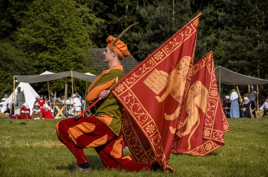 CHORZOW,POLAND, JUNE 9: "Gwardia Gryfa" team performing flag dance during a IV Convention of Christian Knighthood on June 9, 2013, in Chorzow