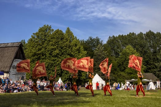 CHORZOW,POLAND, JUNE 9: "Gwardia Gryfa" team performing flag dance during a IV Convention of Christian Knighthood on June 9, 2013, in Chorzow