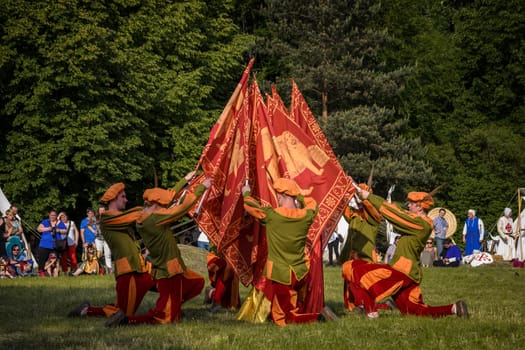 CHORZOW,POLAND, JUNE 9: "Gwardia Gryfa" team performing flag dance during a IV Convention of Christian Knighthood on June 9, 2013, in Chorzow