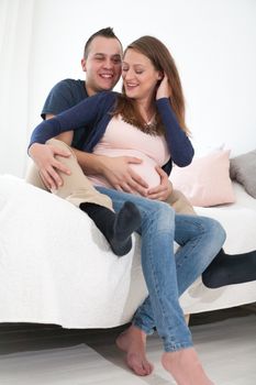 Young pregnant couple is waiting for their little girl