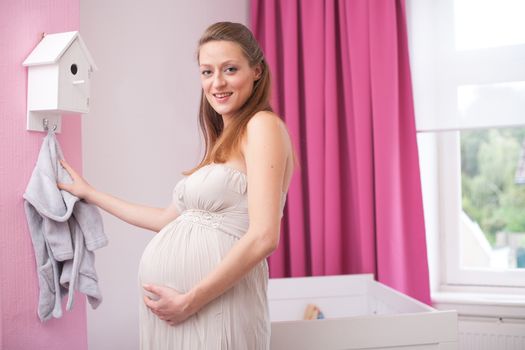 Young new mother in the new babyroom