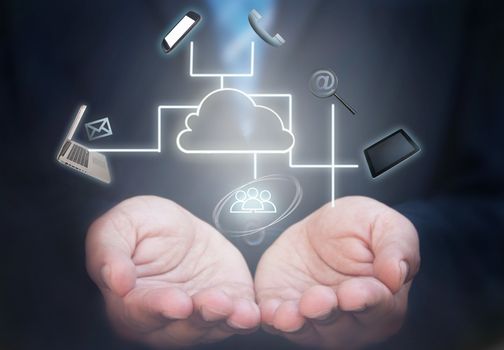 Business man holding a network of computer gadgets and social media icons stemming from a cloud icon