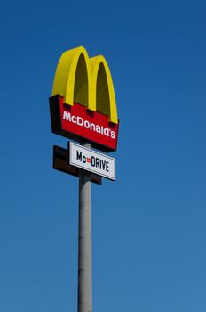 KATOWICE - JULY 13: McDonalds logo on blue sky background on July 13, 2011, Katowice, Poland.  McDonald's Corporation is the world's largest chain of hamburger fast food restaurants.
