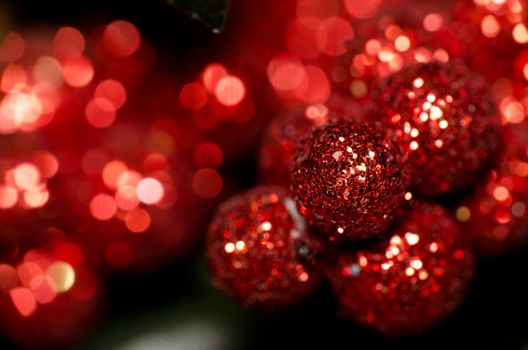 Christmas red shining baubles against red defocused background