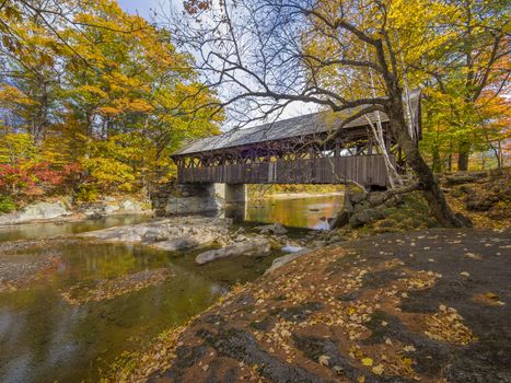 Old covered bridge during the fall season,in the little town of Bethel, Maine, USA