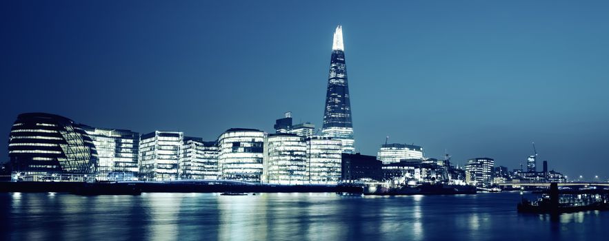 Panoramic view of new London city hall at night, special photographic processing.