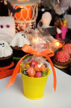 bucket filled with candy table among sweets for Halloween