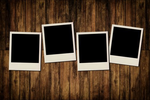 Blank instant photo frames on old wooden background