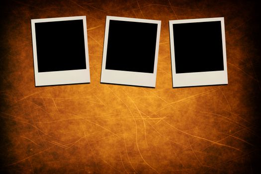 Blank instant photo frames on grunge brown background