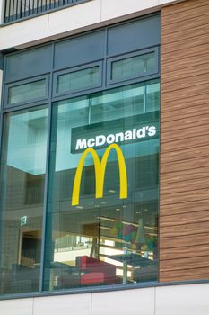 Stuttgart, Germany - November 1, 2013: McDonald's fast food restaurant - window with logo and brand of the fast food chain. The McDonald's Corporation is the world's largest chain selling hamburgers and fast food.
