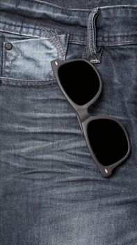 sunglasses on jean pants