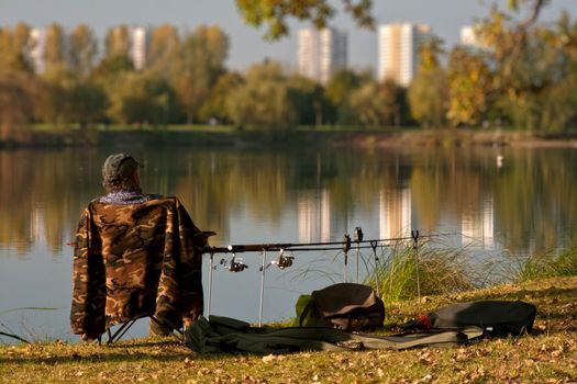 Patient angler sitting by the pond