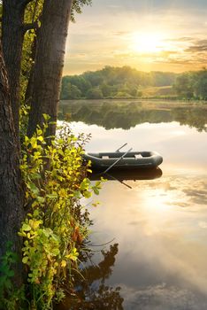 Inflatable boat on river at the sunrise