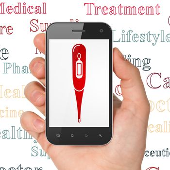 Medicine concept: Hand Holding Smartphone with  red Thermometer icon on display,  Tag Cloud background