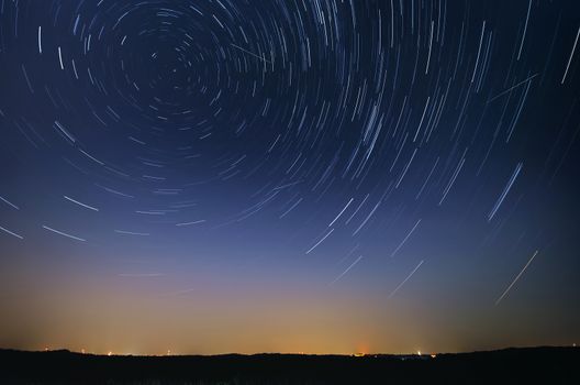 Startrail landscape of moving stars during the night of the Perseid meteor shower