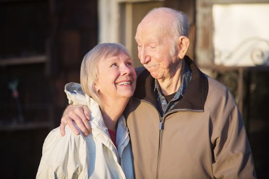 Cute European senior couple outdoors looking at each other