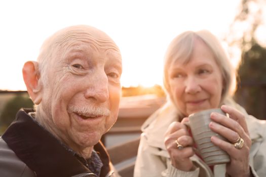 European senior couple together outdoors making jokes