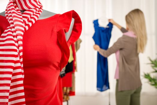 Close-up of a dress on mannequin in fashion designer office.