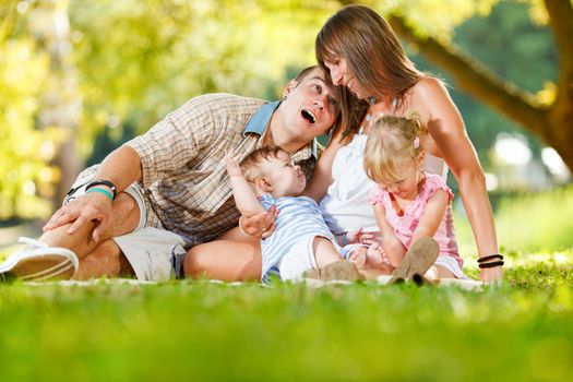 Beautiful happy family enjoying in the park