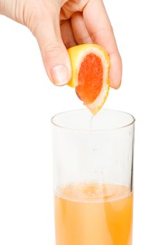 Making freshly squeezed grapefruit juice. White background