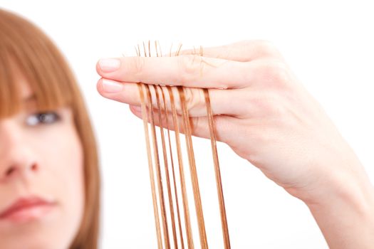 Hairdresser cutting the hair of a blonde woman