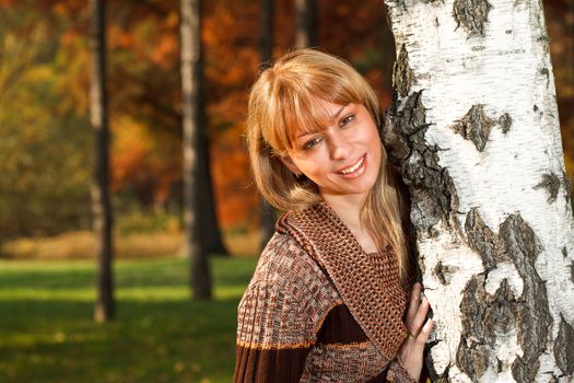 Portrait of beautiful young woman at the park in autumn