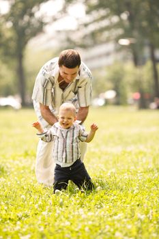 Little boy playing with father in the park