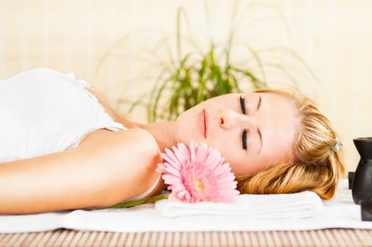 Young beautiful woman relaxing and enjoying at the spa center