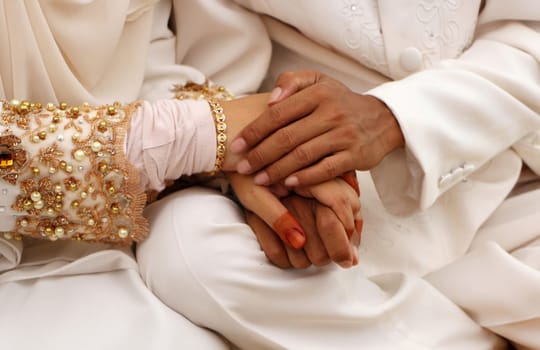 Bride and groom holding hands