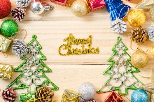 the words merry christmas with christmas decorations on wooden background.