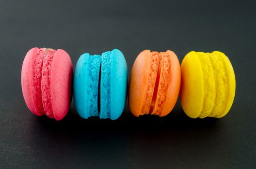 Colorful macaroon on black background.