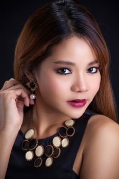 Portrait of young Asian girl - black dress close-up