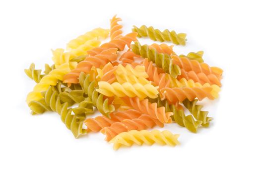 Uncooked italian pasta - three colors spirals on white background.