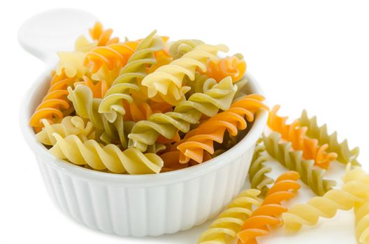 dried italian pasta (macaroni) in white bowl on white background.