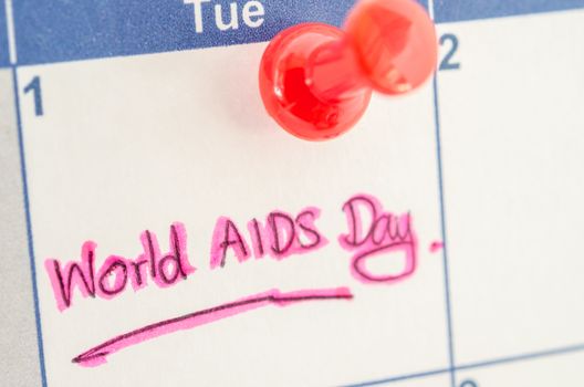 calendar marking the 1st december world aids day with pushpin.