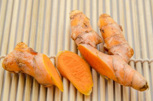 turmeric on bamboo mat background.