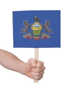 Hand holding small card, isolated on white - Flag of Pennsylvania