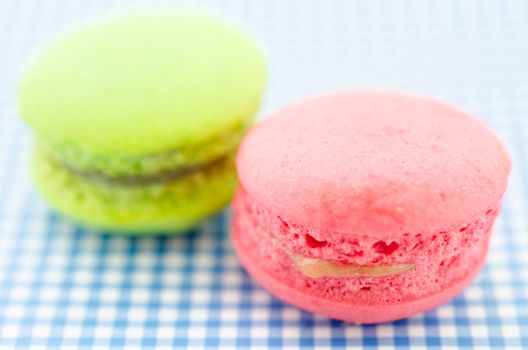 colorful macaroon sweet tasty dessert on tablecloth.