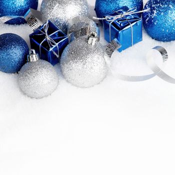 Beautiful various blue and silver christmas decor on snow close-up