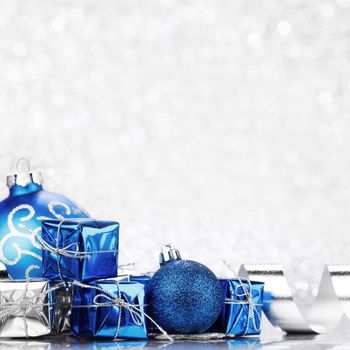 Christmas gifts and decoration on shiny glitter background