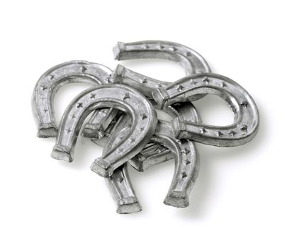 Small horse shoes made of tin, used in Finnish new years ritual where molten tin is used to foresee the coming new year