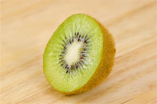 Kiwi fruit isolated on wooden background.