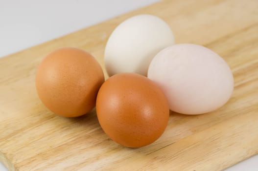 Many eggs on wood background.