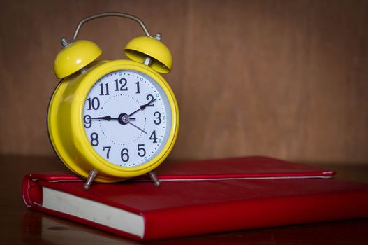 Alarm clock and book.