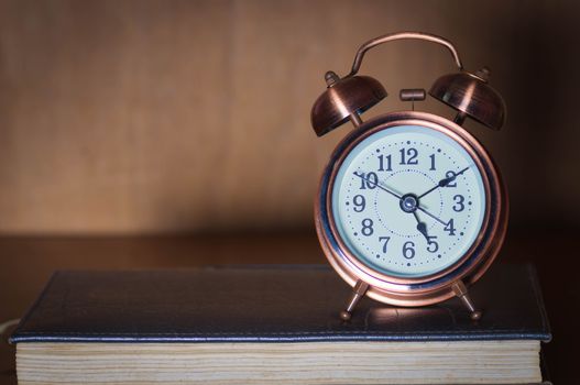 Retro alarm clock and book.