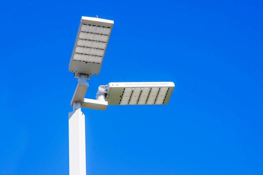 LED Street Lamps Affixed to an Iron Post Against a Deep Blue Sky Affixed to an Iron Post Against a Deep Blue Sky