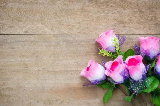 Rose  on wooden table background.