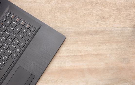 Black notebook on wooden background.